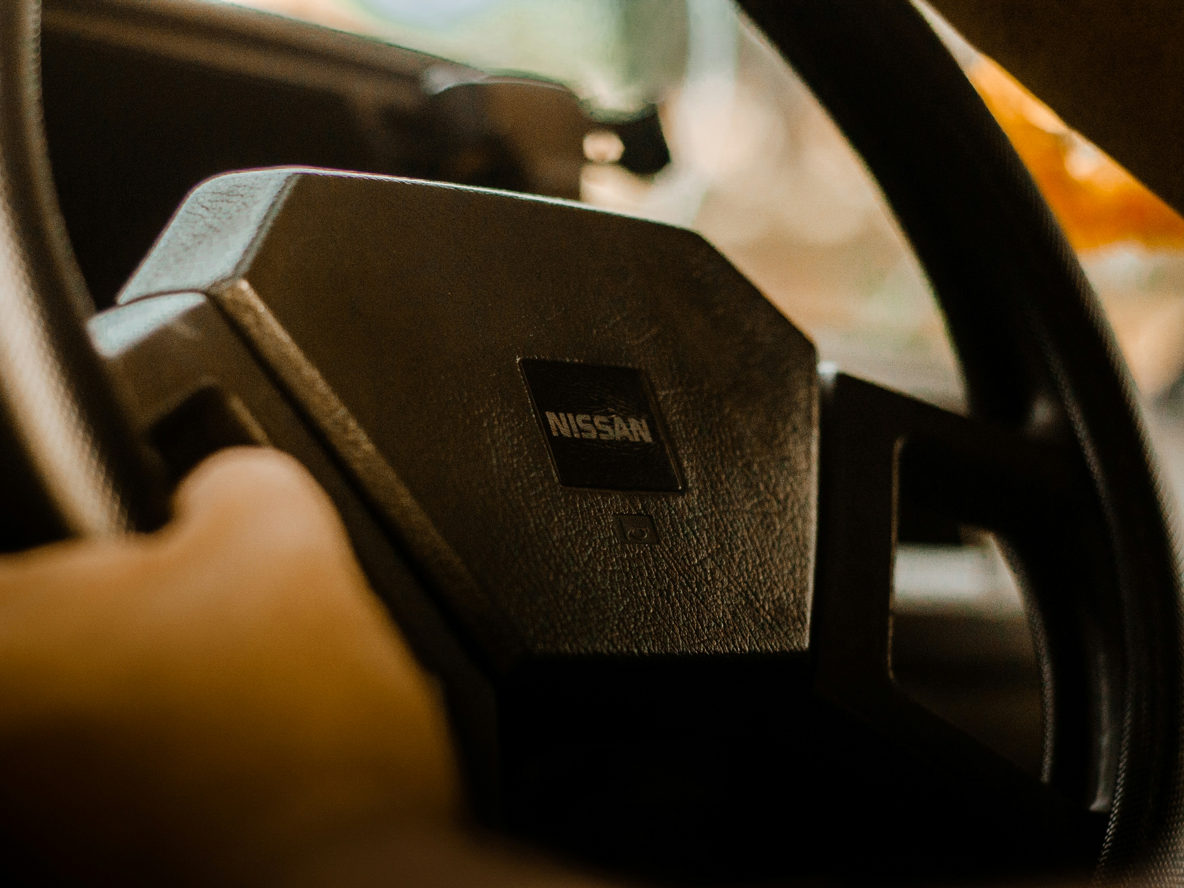 a hand holding a black device