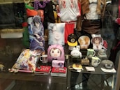 A close-up of various anime accessories laid out on a colorful background.