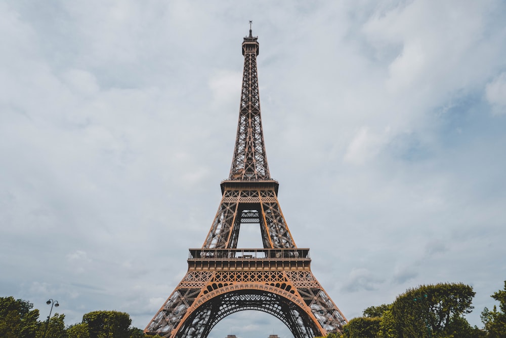 a tall metal tower with Eiffel Tower in the background