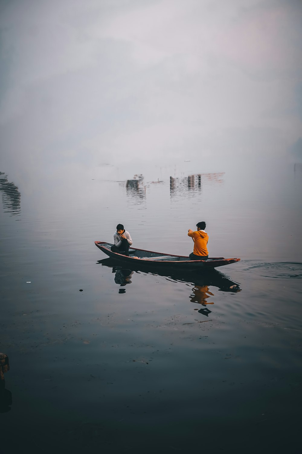 a couple of people in a canoe on a lake