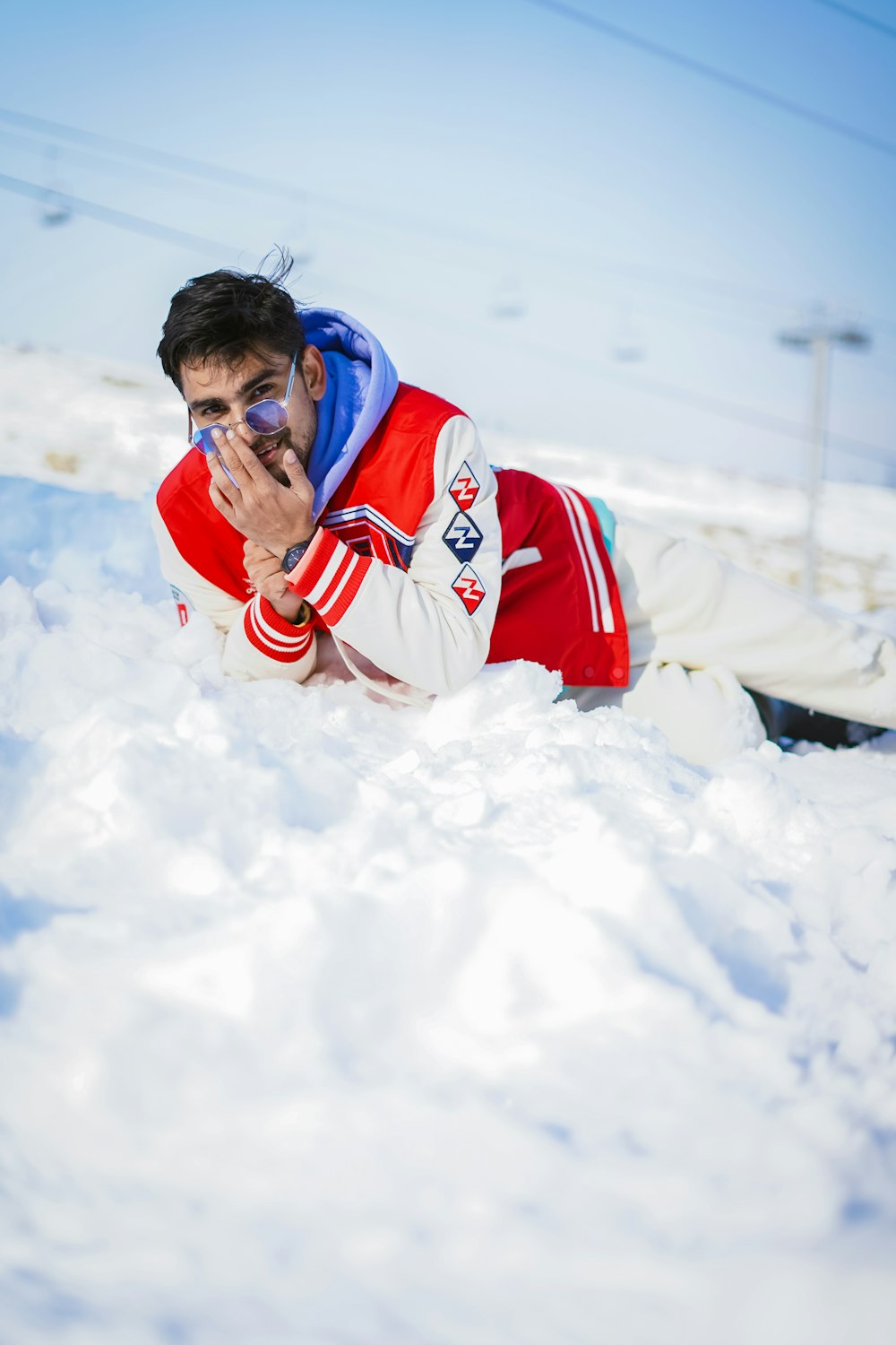 a man in a red and white jacket in the snow