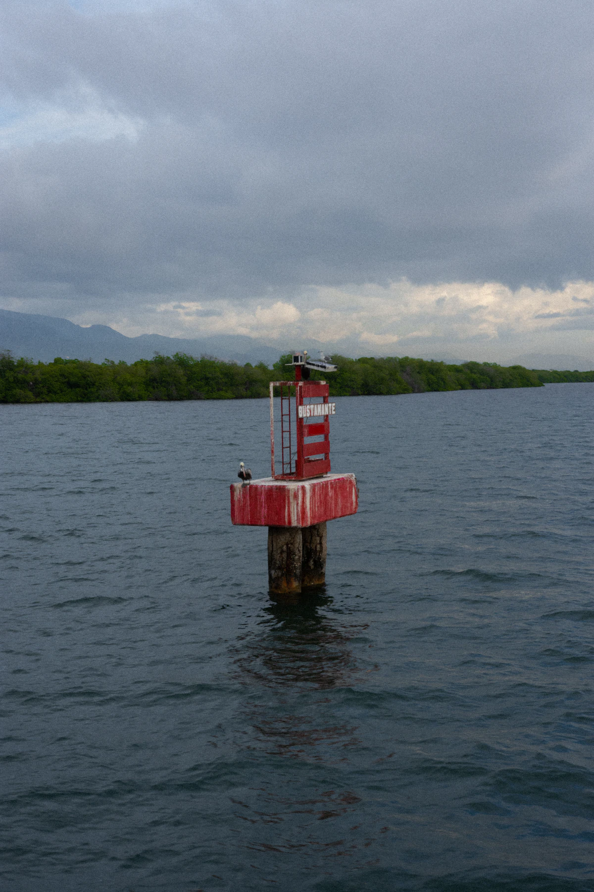 Red lighthouse structure in Kingston Harbour, Jamaica, no people visible