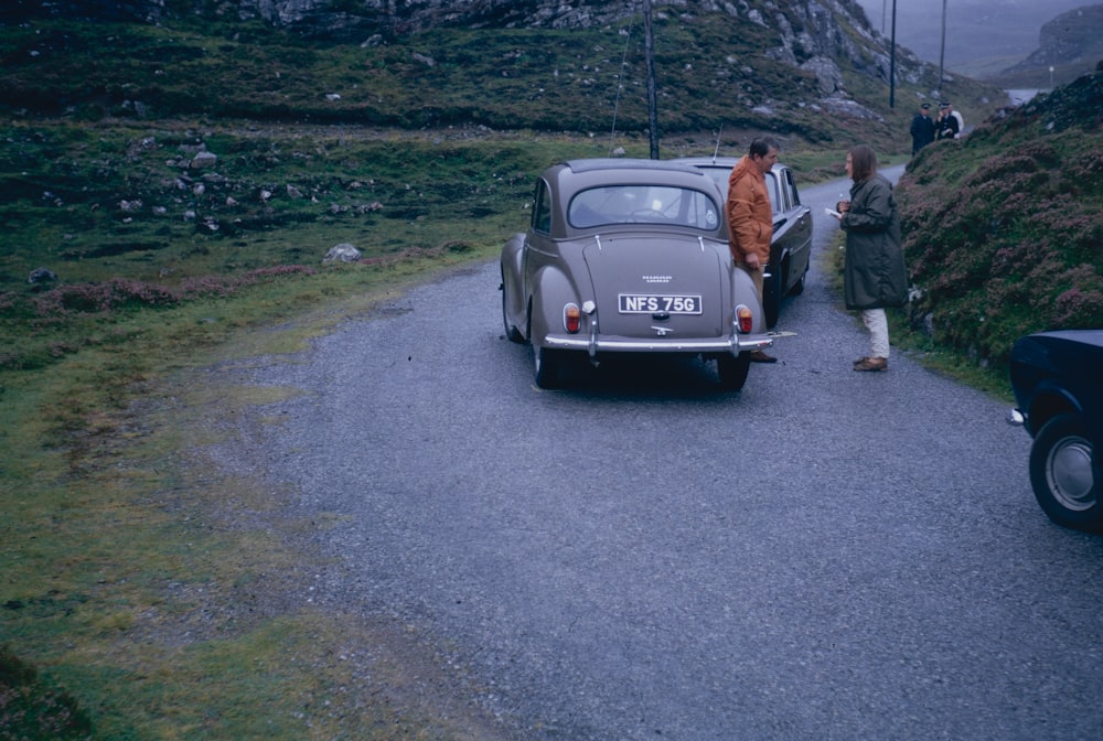 a man standing next to a car