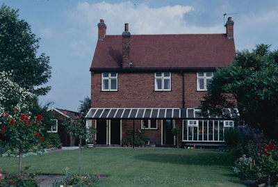 A beautiful two-story house with a well-maintained garden.