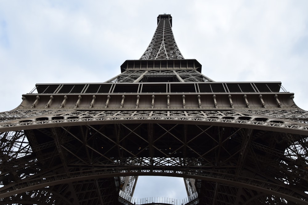 a large metal tower with Eiffel Tower in the background