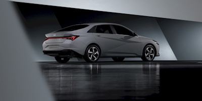 A sleek sedan shown in a 360-degree digital spin on a smartphone screen.