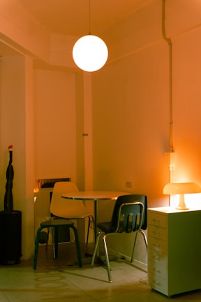 Cozy meeting room with a round table and soft earthy-toned chairs.