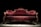 A luxurious Victorian-style sofa with elegant, deep red velvet upholstery and ornate wooden carvings. The setting is dramatically lit, highlighting the intricate textures and curves of the sofa against a dark background.