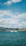 A joyful customer speeding across turquoise waters on a jet ski under a bright sunny sky.