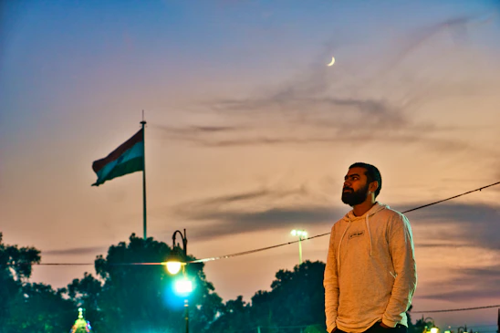 A thoughtful man standing strong against a sunrise, symbolizing hope and leadership.