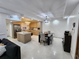 Modern kitchen featuring stainless steel appliances and a neatly arranged dining area.