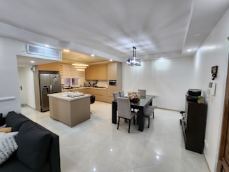 Modern kitchen with stainless steel appliances and an inviting dining area.