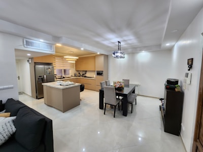 Modern kitchen featuring stainless steel appliances and a neatly arranged dining area.
