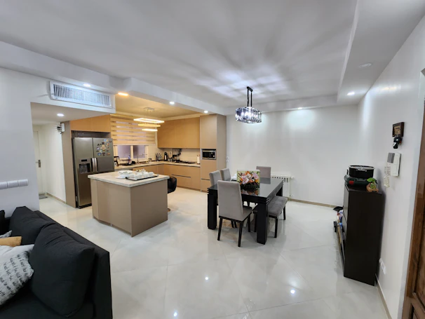 Fully furnished kitchen in Tropicana 218 Macalister with sleek appliances and dining space