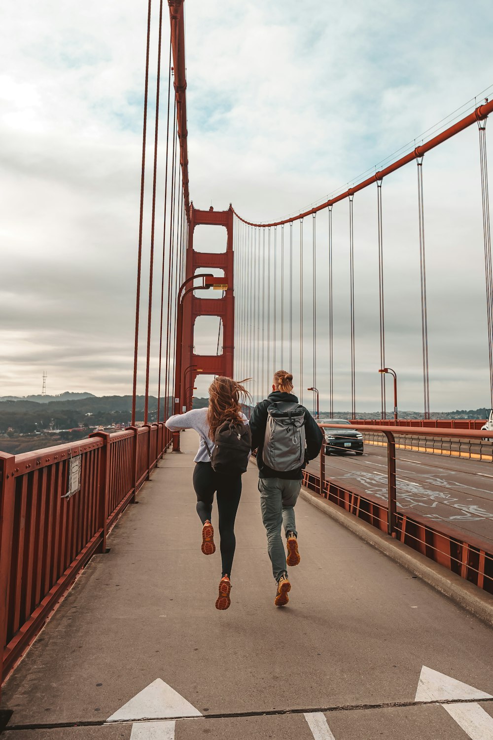 a man and woman walking on a bridge