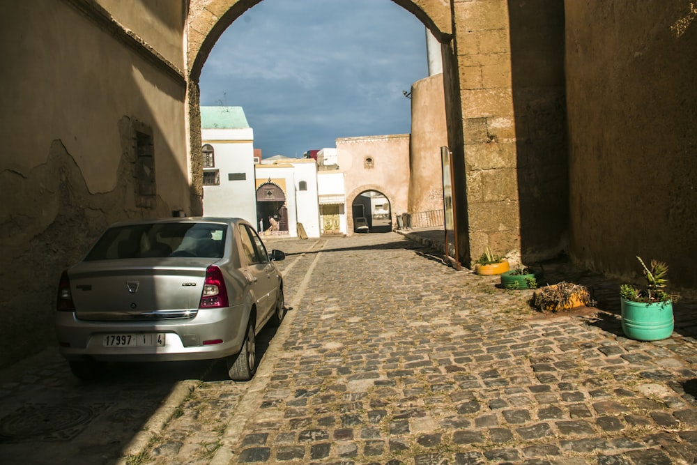 a car parked in a narrow alley