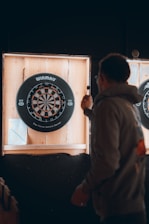 a man holding a dart board