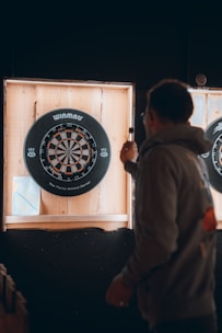 a man holding a dart board