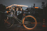 Image of a bicycle locked near a street lamp at dusk