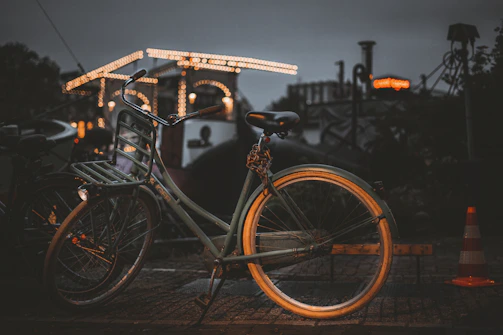 Image of a bicycle locked near a street lamp at dusk