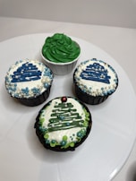 Festive Christmas-themed cupcake decorated with green and red icing and tiny edible snowflakes.