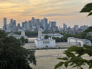 A panoramic cityscape showing smart infrastructure blending with green spaces at sunset.