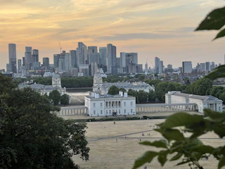 A panoramic view of Bucharest cityscape at sunset with historic and modern buildings