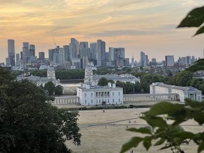 A panoramic cityscape showing smart infrastructure blending with green spaces at sunset.