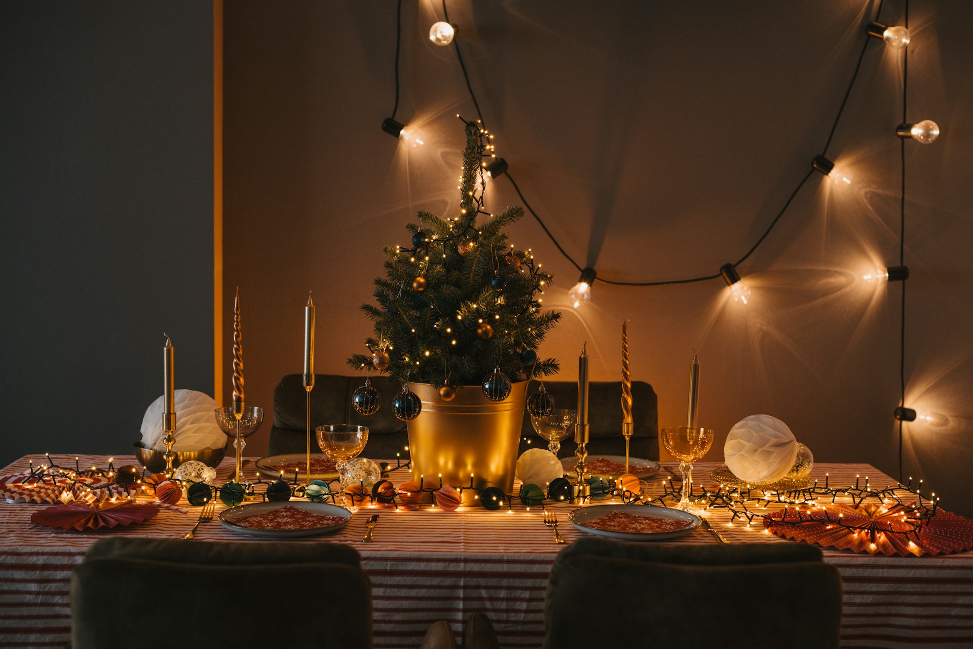 a table with a christmas tree and candles on it