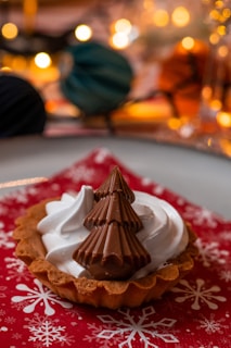 Close-up of a beautifully decorated Christmas dessert with powdered sugar and berries