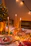 Elegant Christmas table setting with warm lights and golden details.
