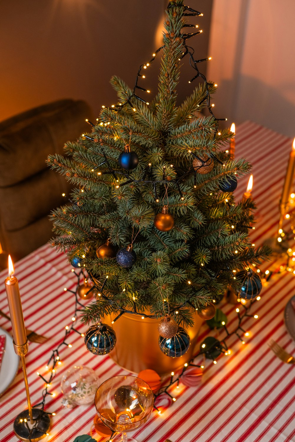 a christmas tree with candles and ornaments