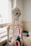 A detailed anatomical skeleton model with painted features, such as muscles and arteries, is positioned beside a window in a room that appears to be an educational or medical setting. The skeleton is primarily white, with highlights in red and blue on the ribs and arms, illustrating different anatomical systems.