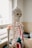 A detailed anatomical skeleton model with painted features, such as muscles and arteries, is positioned beside a window in a room that appears to be an educational or medical setting. The skeleton is primarily white, with highlights in red and blue on the ribs and arms, illustrating different anatomical systems.