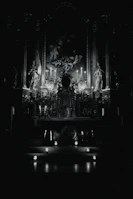 Candles lit in front of an altar dedicated to Our Lady, casting warm shadows.