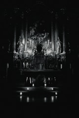 A warm, inviting altar adorned with colorful candles, herbs, and statues of Orishas in a cozy shop setting.