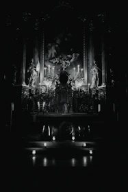 Softly lit altar setup featuring candles, statues, and handcrafted religious items.