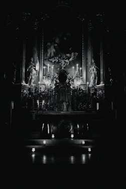 A warm, softly lit altar with candles, saint images, and spiritual tools arranged carefully.