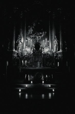 A serene altar decorated with candles, flowers, and symbols of Oxum, glowing warmly in a dim room.