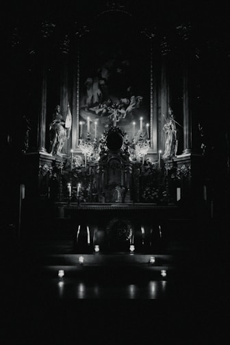 A cozy altar setup with spooky-cute printable art and candles casting warm shadows.