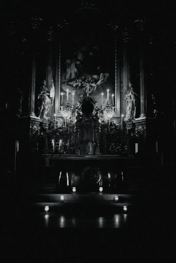 A warm, softly lit altar with candles, saint images, and spiritual tools arranged carefully.