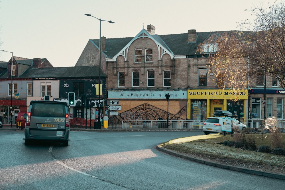 a building with a gate and cars parked in front