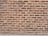Rows of red bricks with varying shades, neatly arranged in a horizontal pattern, set against a light mortar.