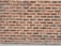Rows of red bricks with varying shades, neatly arranged in a horizontal pattern, set against a light mortar.