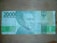 A 20000 Indonesian Rupiah banknote with a portrait of a historical figure on the right side. The note features intricate patterns and security details, along with text indicating its denomination and the country of origin.