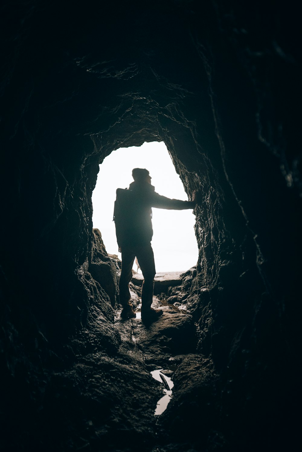 a person standing in a cave