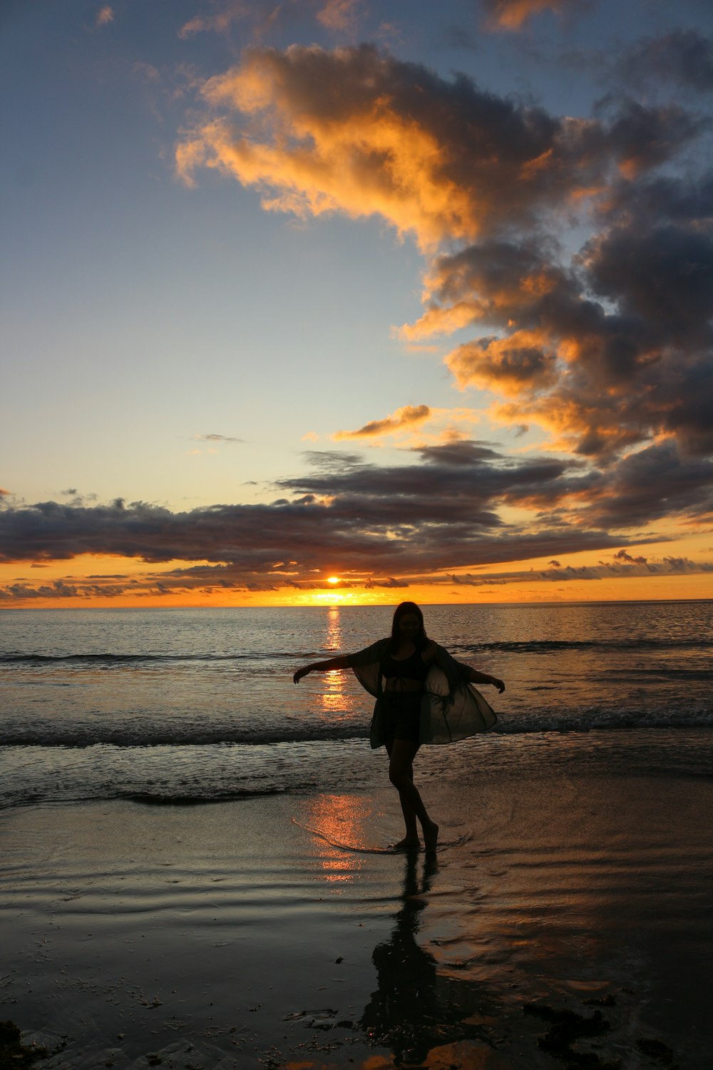 a person carrying a surfboard on a beach