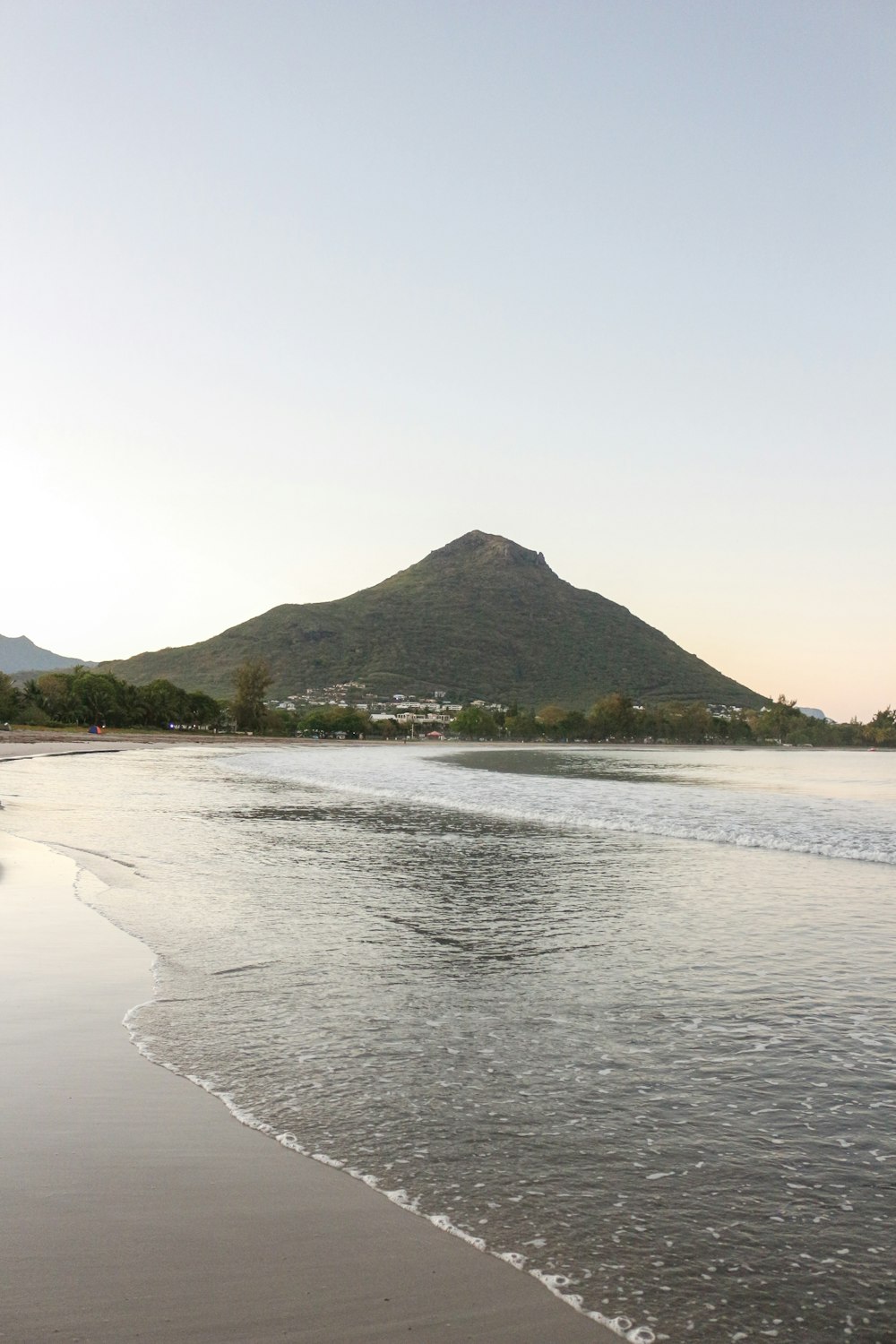 a beach with a mountain in the background