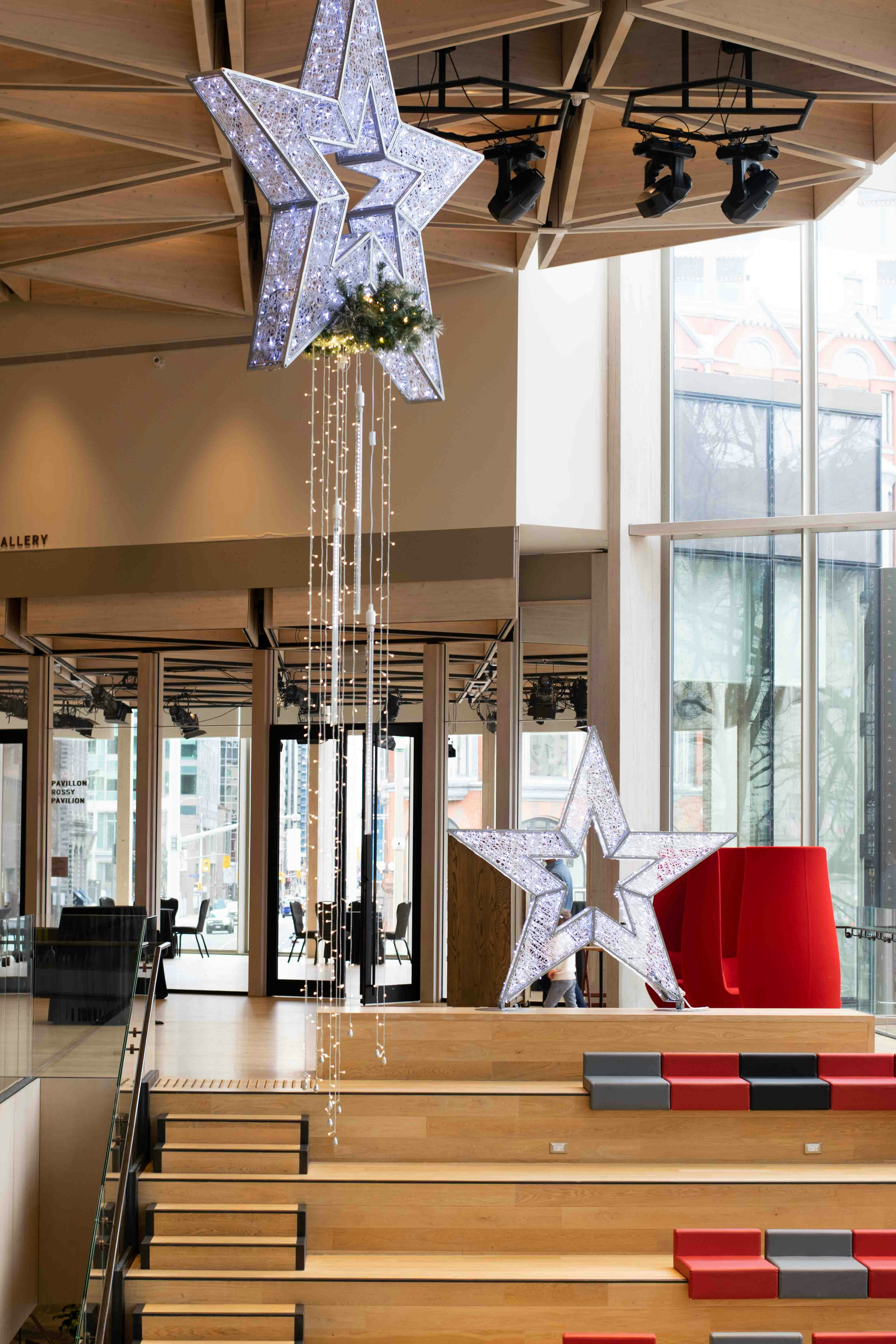 a chandelier from a ceiling in a room with a staircase