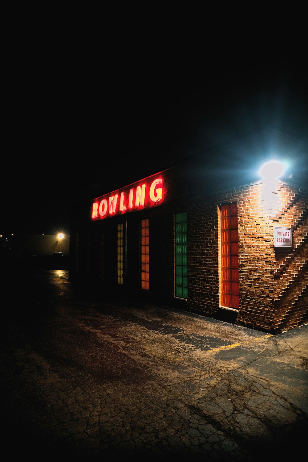 a brick building with a sign on it at night